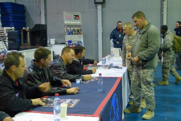 nhra drivers signing autographs for troops stationed overseas