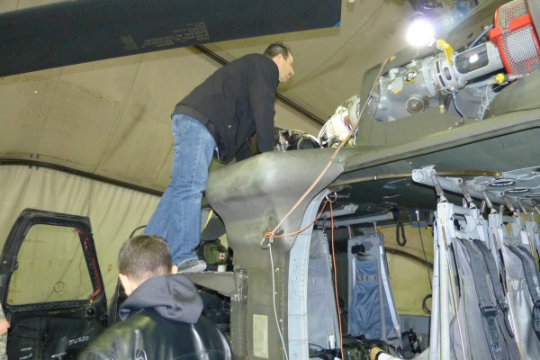Greg Anderson inspecting motor of a Blackhawk helicopter