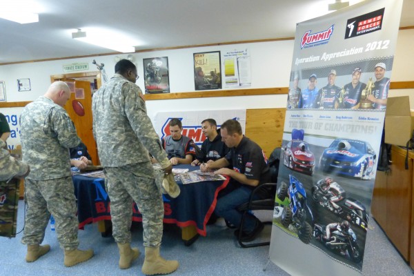 nhra drivers signing autographs with military troops overseas