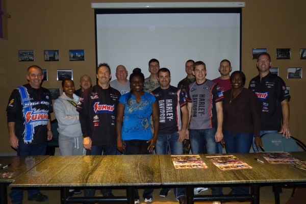 nhra drivers posing for picture with military troops overseas