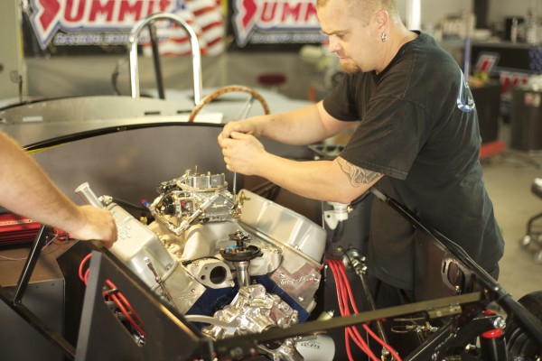 adjusting a carburetor on an engine