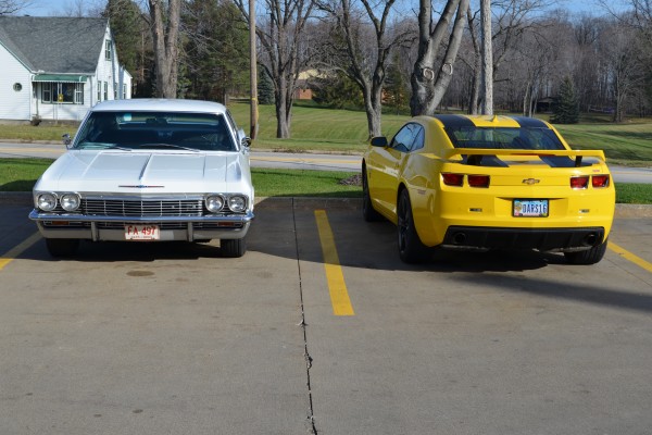 a white 1965 chevy impala 327 coupe and late model camaro