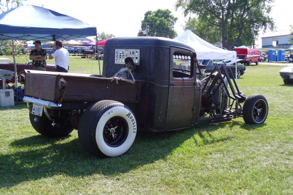 rear view of a rat rod truck with skeleton in bed