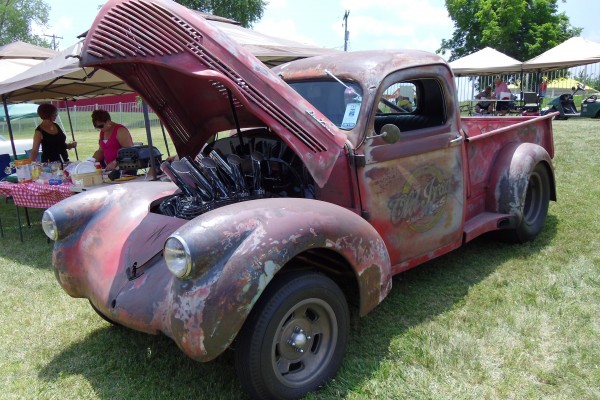 rat rod truck parked at car show