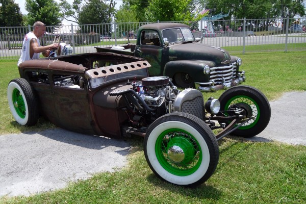 lowered rat rod coupe parked on grass