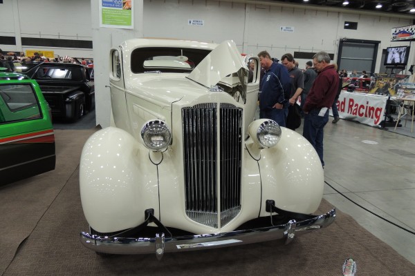 white custom prewar luxury coupe at a car show