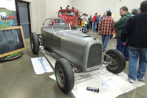 hot rod in bare steel at a car show