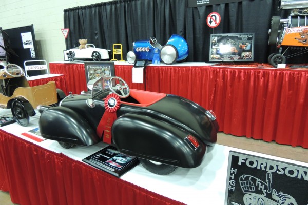 pedal cars on display at car show