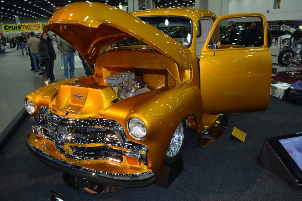 gold chevy 3100 truck at indoor car show