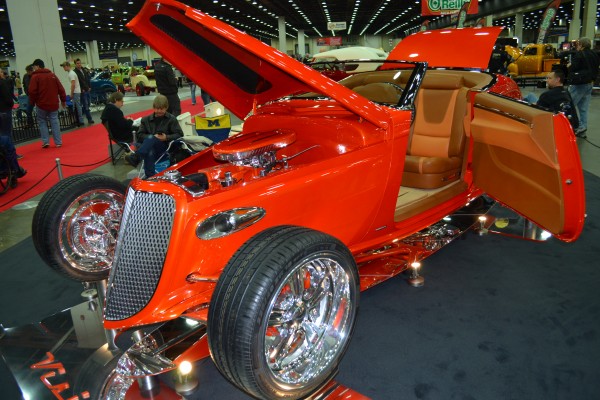 custom red hot rod coupe in a car show display