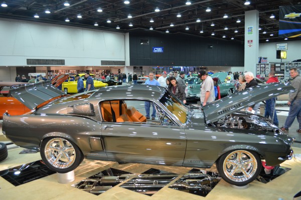 customized ford mustang fastback coupe in car show display