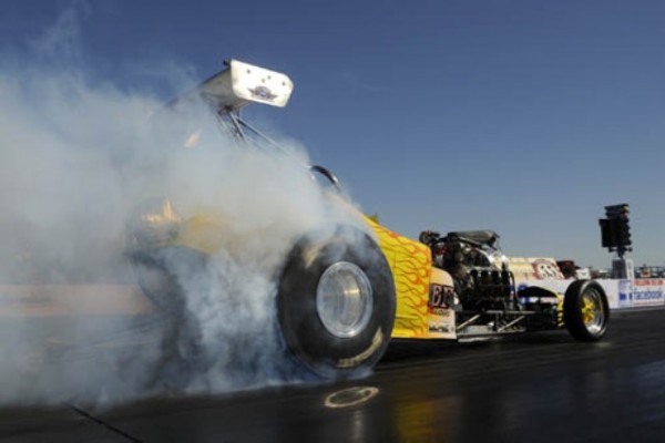 dragster doing a burnout at the strip