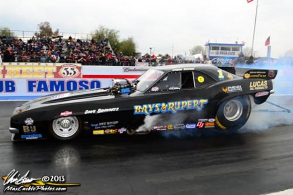 nostalgia funny car doing a burnout at the track