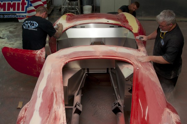 sanding and applying body filler to a classic car