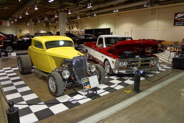 vintage hot rod and truck displayed at indoor car show