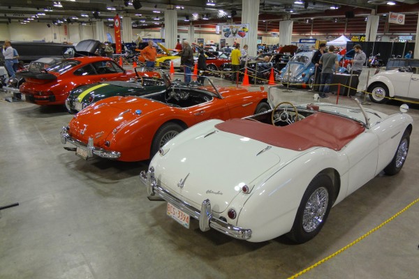 row of austin healey and other vintage European sports cars at a show