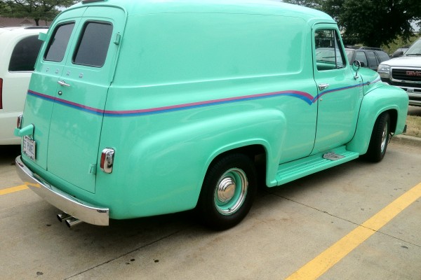 rear view of a customized seafoam 1955 ford panel van