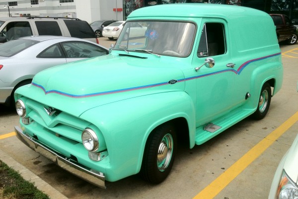front quarter shot of a customized seafoam 1955 ford panel van