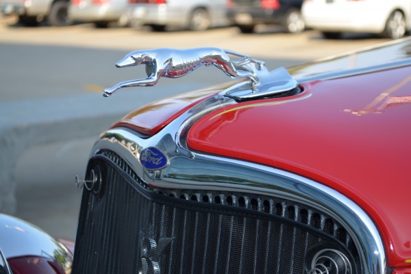 close up of greyhound hood ornament on ford hot rod