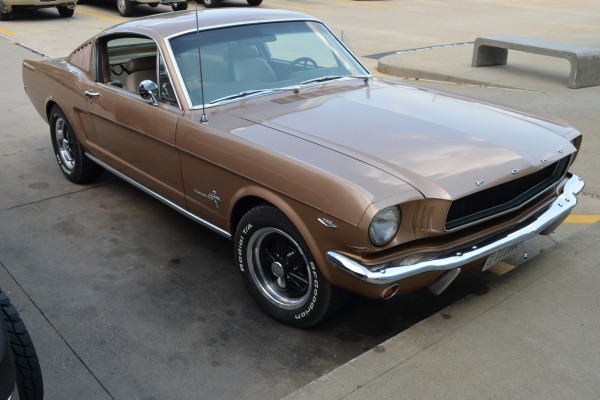 fastback first gen ford mustang in parking lot