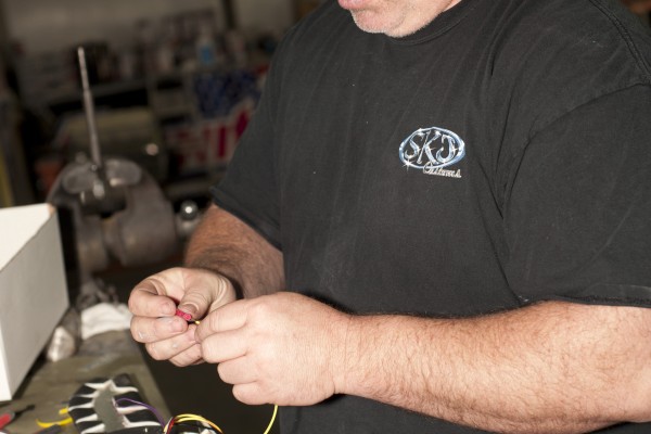man wiring gauges to a kit car
