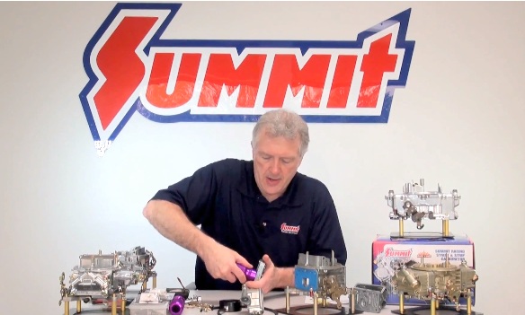 man adjusting a carburetor in a video still