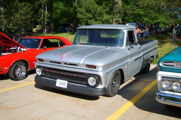 Vintage Chevy C10 pickup truck with d-window wheels and pinstripes