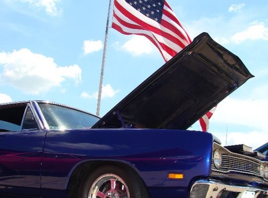 dodge super bee in front of American flag