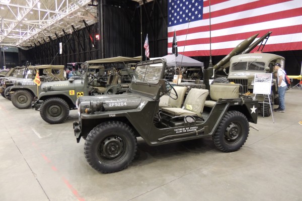 row of military vehicles in a car show display