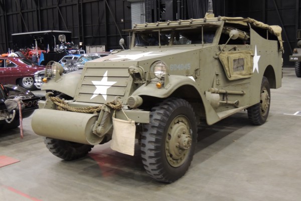 Military troop transport displayed at large indoor car show