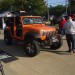 Orange Jeep Wrangler Sport Unlimited with winch and doors removed thumbnail
