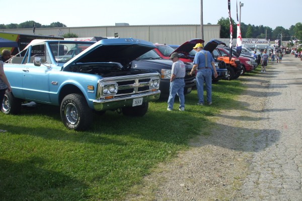 row of custom trucks at a classic car show