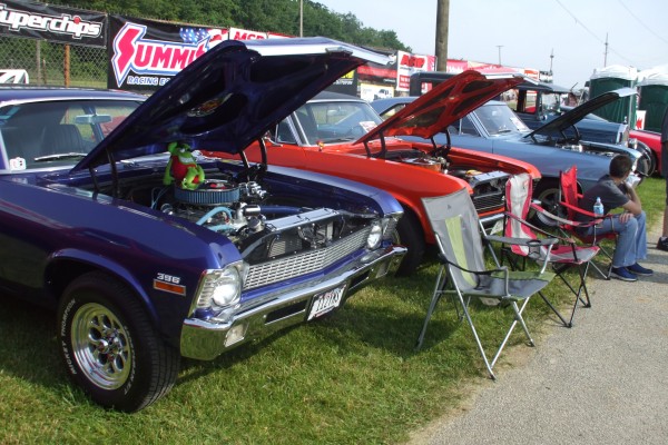 row of muscle cars at a car show