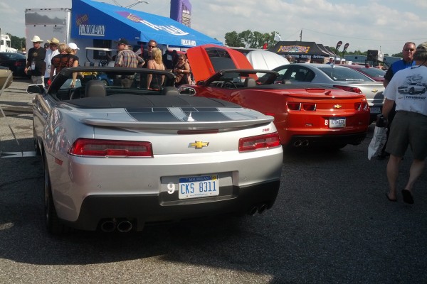 rear view of late model camaros at a car show