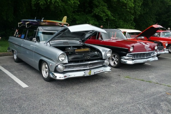 pair of 1950s era fords at a car show