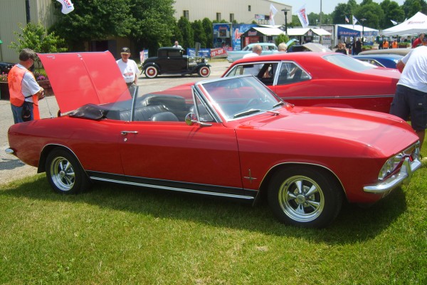 red second gen chevy corvair convertible with custom wheels