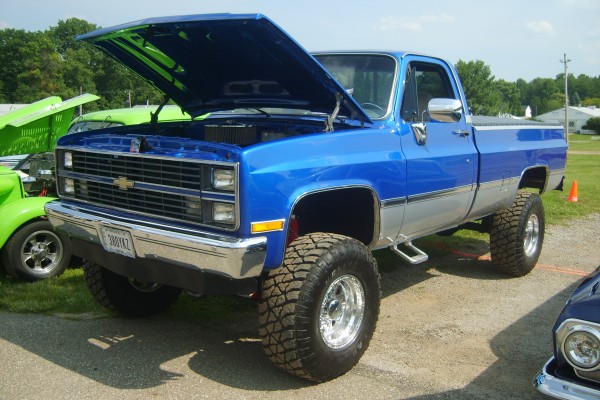 lifted blue chevy Squarebody pickup truck