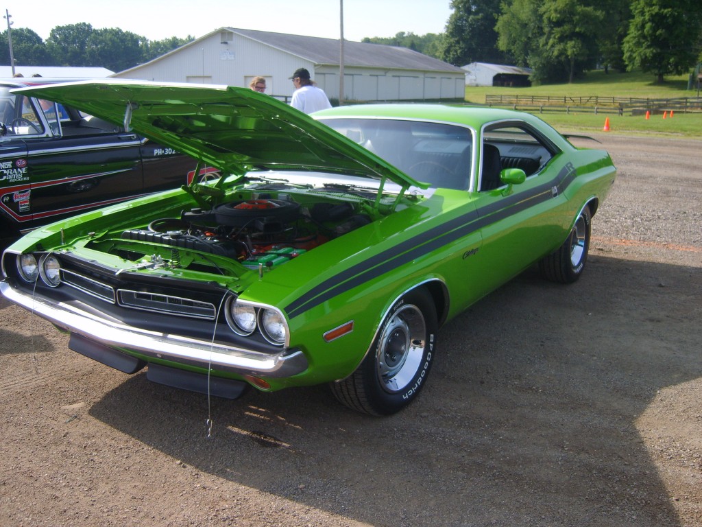 first generation green dodge challenger r/t at a car show