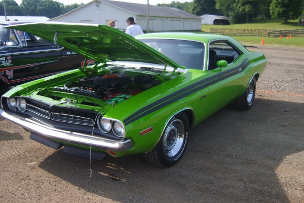 first generation green dodge challenger r/t at a car show