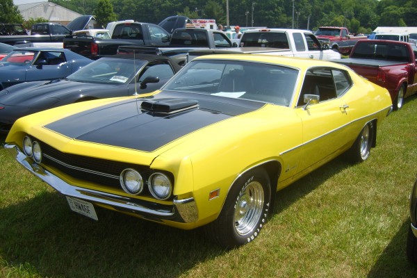 yellow ford torino muscle car