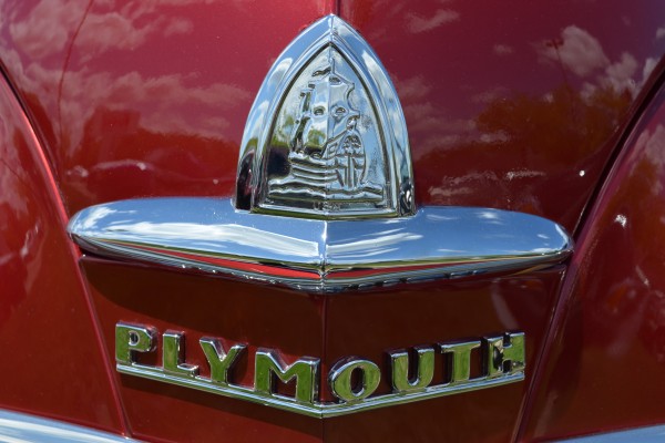 ship emblem hood ornament of a vintage antique plymouth coupe