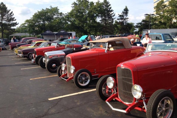 row of hot rods at a large show