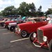 row of hot rods at a large show thumbnail