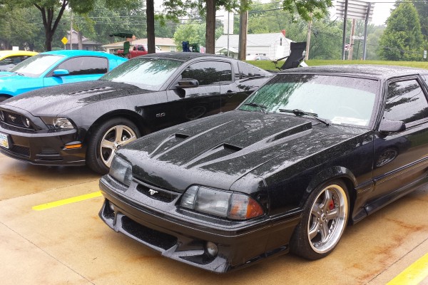 row of ford mustangs at a car show