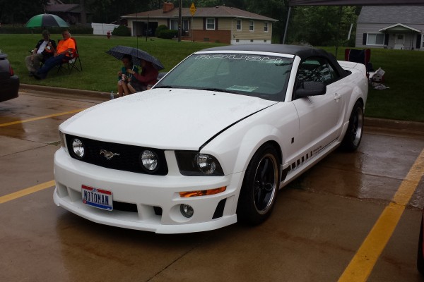 white s197 mustang convertible at a car show