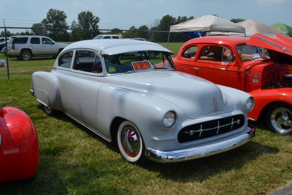 postwar chevy lowrider hot rod coupe at a car show