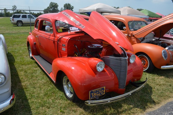 red 1939 hot rod coupe at a car show