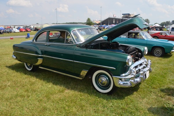 green chevy postwar coupe at a car show