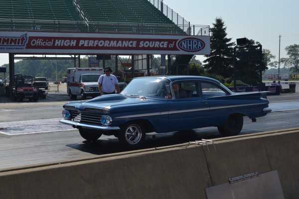 vintage chevy coupe prepping a run down a dragstrip