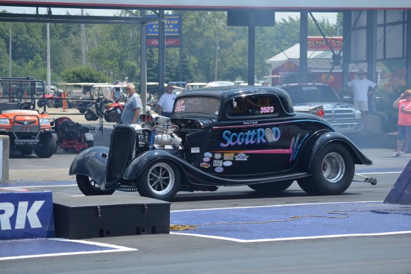 ford coupe hotrod dragster on drag race track